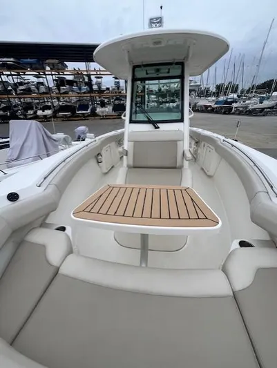  Yacht Photos Pics 2020 Boston Whaler 280 Outrage boat interior with seating and table.