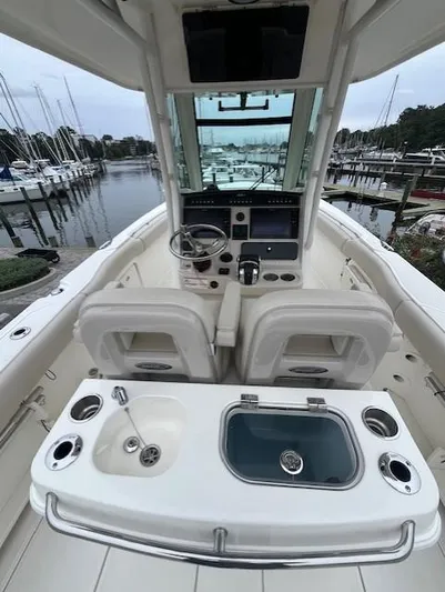  Yacht Photos Pics 2020 Boston Whaler 280 Outrage boat interior with helm and seating, docked at marina.