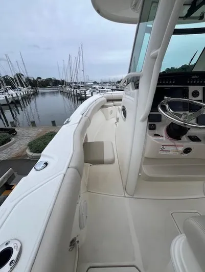  Yacht Photos Pics 2020 Boston Whaler 280 Outrage boat docked at marina, showcasing sleek design and helm.