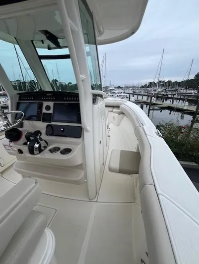  Yacht Photos Pics 2020 Boston Whaler 280 Outrage boat interior at marina, showcasing helm and seating.