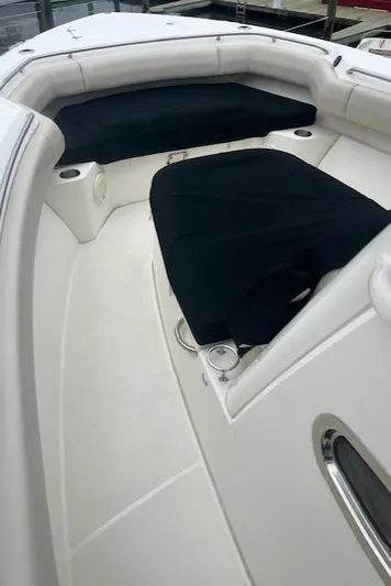  Yacht Photos Pics 2020 Boston Whaler 280 Outrage boat interior with cushioned seating and cup holders.