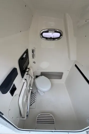  Yacht Photos Pics Interior of 2020 Boston Whaler 280 Outrage boat bathroom with toilet and window.