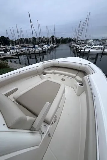  Yacht Photos Pics 2020 Boston Whaler 280 Outrage boat with spacious seating in a marina.