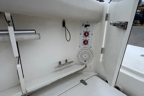  Yacht Photos Pics Boston Whaler 280 Outrage 2020 boat interior with storage compartment and controls.