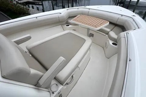  Yacht Photos Pics 2020 Boston Whaler 280 Outrage boat interior with seating and table.