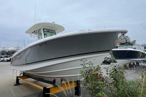 Yacht Photos Pics 2020 Boston Whaler 280 Outrage boat on display in a marina setting.