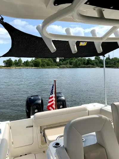  Yacht Photos Pics 2020 Boston Whaler 280 Outrage boat on water, featuring American flag and dual engines.
