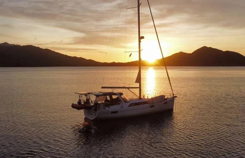 Wanderer Yacht Photos Pics 2019 Beneteau Oceanis 41.1 sailboat at sunset on calm waters.