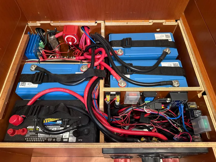 Wanderer Yacht Photos Pics Battery compartment of a 2019 Beneteau Oceanis 41.1 sailboat, featuring multiple batteries and wiring.