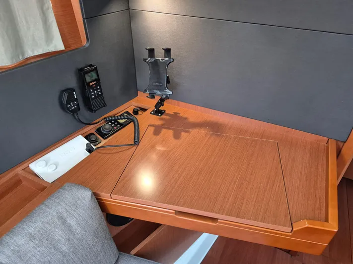 Wanderer Yacht Photos Pics Navigation station in 2019 Beneteau Oceanis 41.1 yacht with communication equipment and wooden desk.