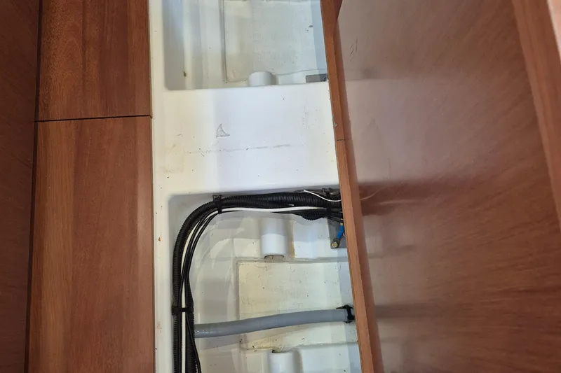 Wanderer Yacht Photos Pics Interior view of 2019 Beneteau Oceanis 41.1 yacht showing wiring and wooden paneling.