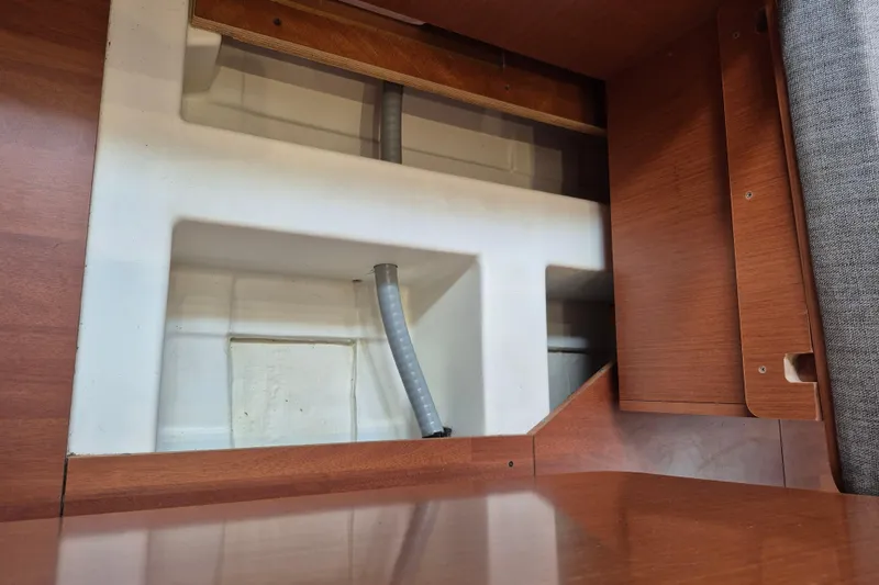 Wanderer Yacht Photos Pics Interior compartment of a 2019 Beneteau Oceanis 41.1 sailboat, featuring wood paneling and storage space.