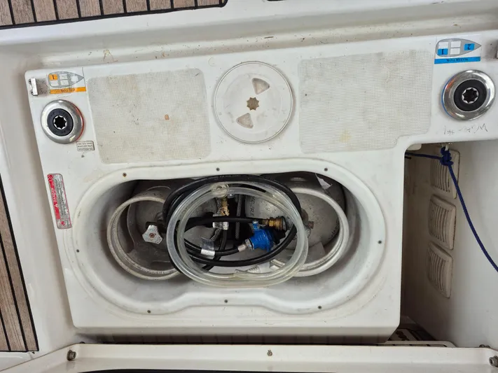 Wanderer Yacht Photos Pics Storage compartment on a 2019 Beneteau Oceanis 41.1 sailboat, featuring hoses and fittings.
