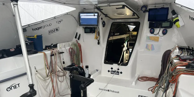 Ocean Calling Yacht Photos Pics Cockpit of 2007 Hake Seaward Open 60 sailboat with navigation equipment and ropes.