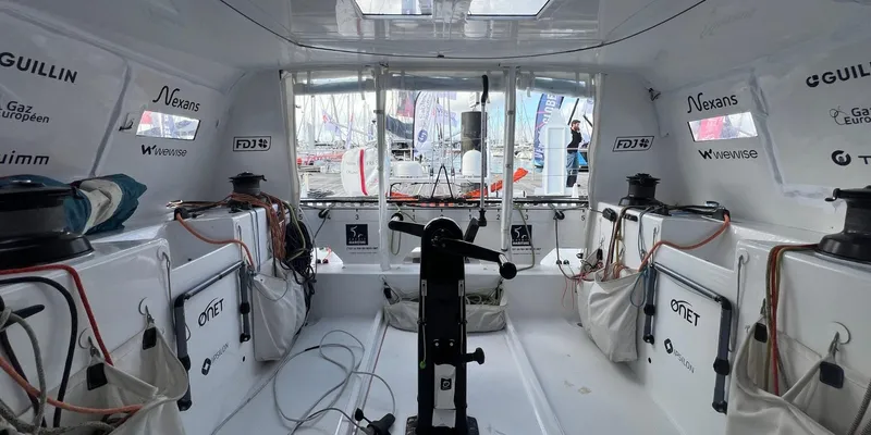 Ocean Calling Yacht Photos Pics Interior of 2007 Hake/Seaward Open 60 sailboat, featuring navigation equipment and sponsor logos.