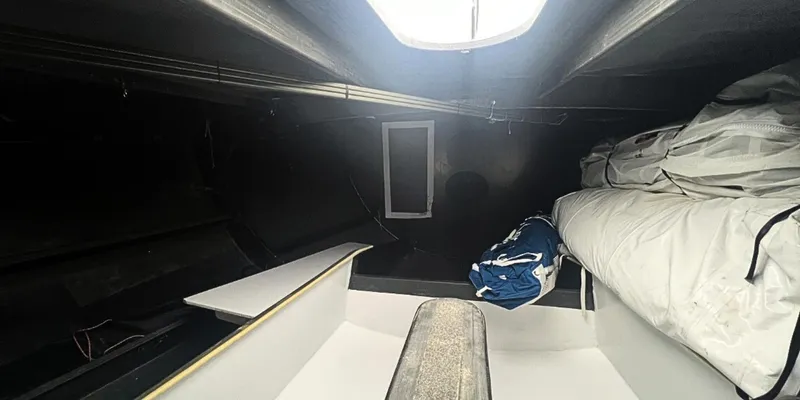 Ocean Calling Yacht Photos Pics Interior of 2007 Hake Seaward Open 60 sailboat, featuring storage and sleeping area.