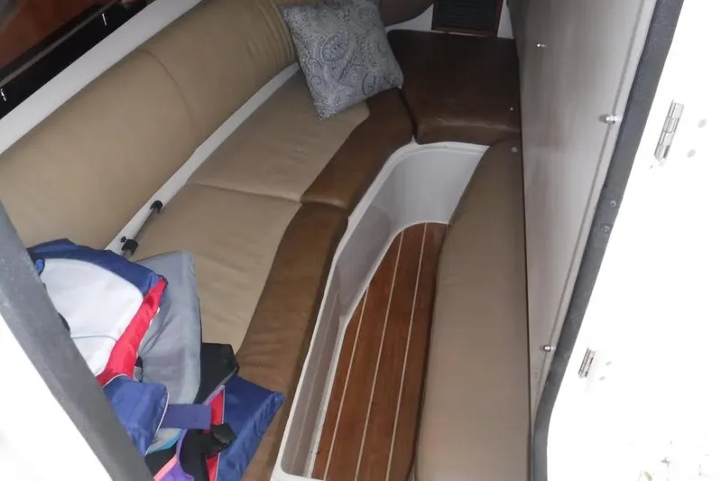  Yacht Photos Pics Interior cabin of 2014 Grady-White Freedom 335 boat with cushioned seating and wooden flooring.