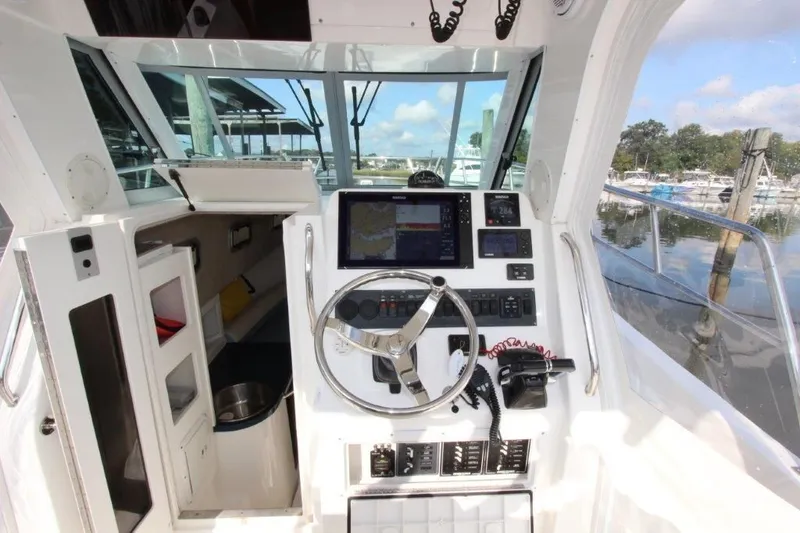 No Name Yacht Photos Pics 2015 True World Marine TE 289 boat cockpit with steering wheel and navigation equipment.