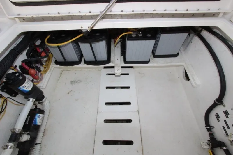 No Name Yacht Photos Pics Engine compartment of a 2015 True World Marine TE 289 boat, showing batteries and wiring.