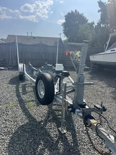 No Name Yacht Photos Pics 2015 True World Marine TE 289 boat trailer on gravel lot, sunny day.