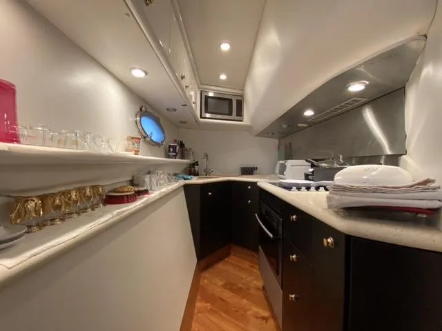 The Enterprise Yacht Photos Pics Luxurious kitchen interior of a 1995 Sunseeker MANHATTAN yacht with modern amenities.