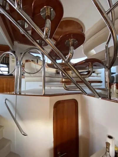 The Enterprise Yacht Photos Pics Interior view of 1995 Sunseeker MANHATTAN yacht with elegant wood and metal staircase.