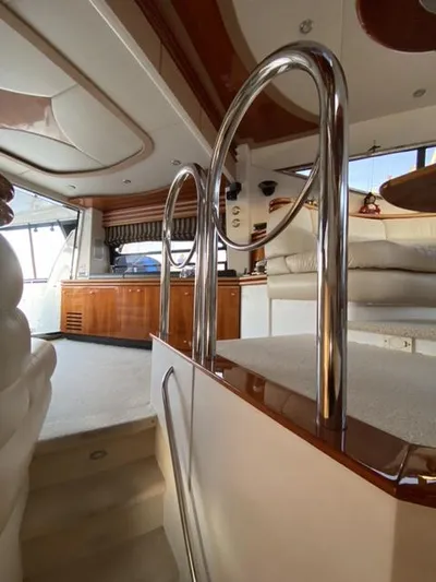 The Enterprise Yacht Photos Pics Interior of a 1995 Sunseeker Manhattan yacht, featuring elegant wood and chrome finishes.