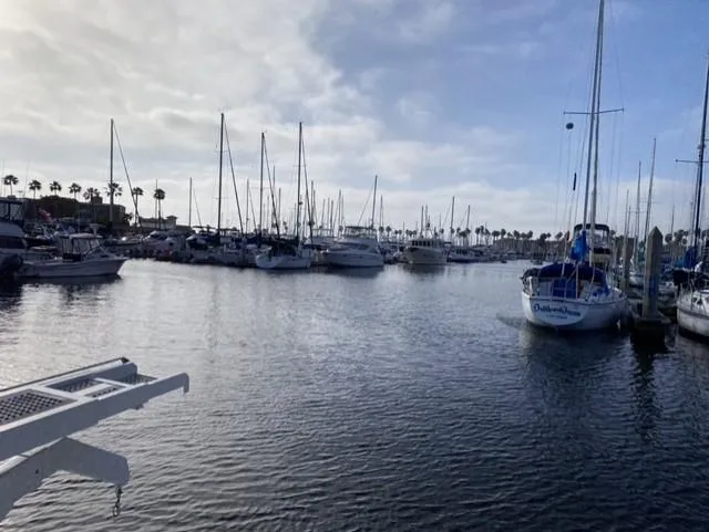 The Enterprise Yacht Photos Pics Marina with various sailboats, including a 1995 Sunseeker MANHATTAN, under a cloudy sky.