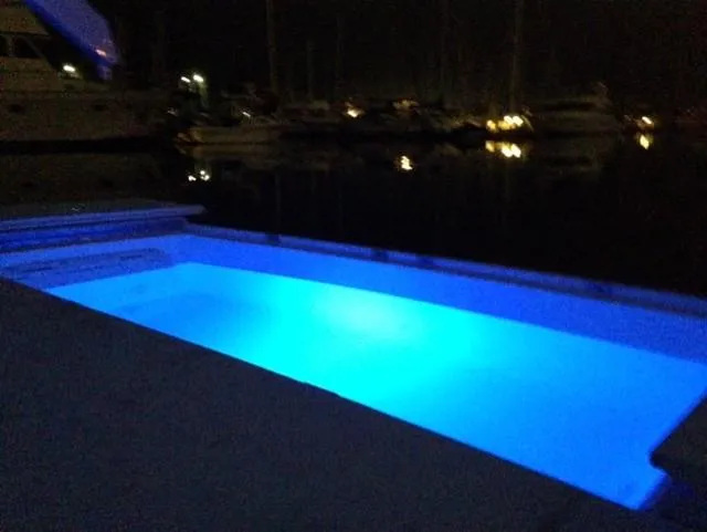 The Enterprise Yacht Photos Pics Illuminated pool on a 1995 Sunseeker MANHATTAN yacht at night.