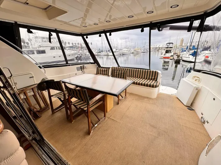 The Enterprise Yacht Photos Pics Sunseeker MANHATTAN 1995 yacht interior with dining area overlooking marina.