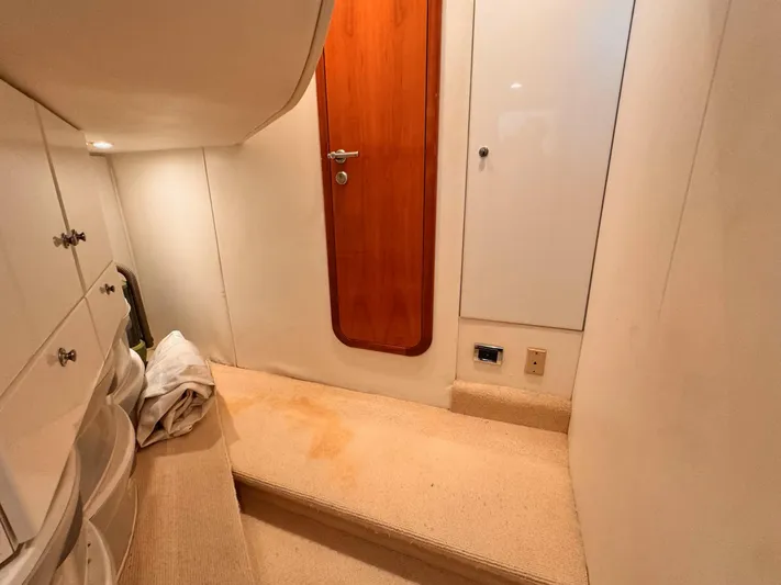 The Enterprise Yacht Photos Pics Interior of 1995 Sunseeker MANHATTAN yacht with wooden door and carpeted floor.