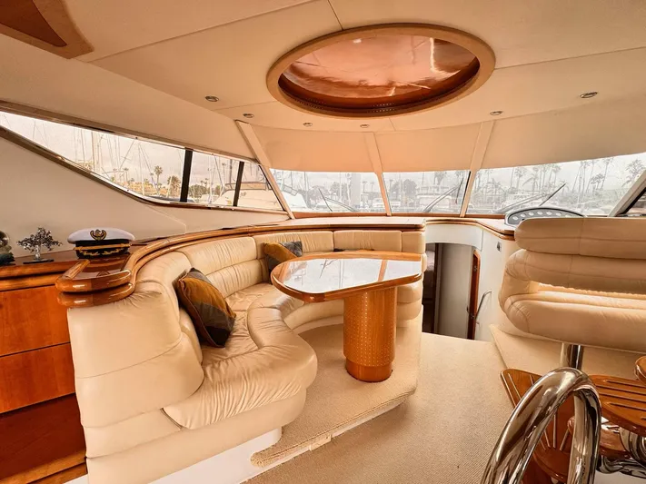 The Enterprise Yacht Photos Pics Luxurious interior of a 1995 Sunseeker MANHATTAN yacht with elegant seating and wooden accents.