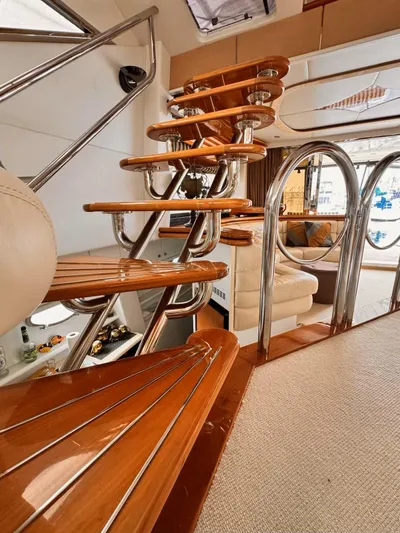 The Enterprise Yacht Photos Pics Interior of 1995 Sunseeker MANHATTAN yacht with elegant wooden staircase and modern design.