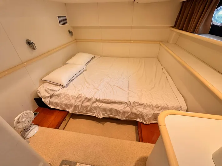 The Enterprise Yacht Photos Pics Cozy bedroom in 1995 Sunseeker MANHATTAN yacht with double bed and soft lighting.