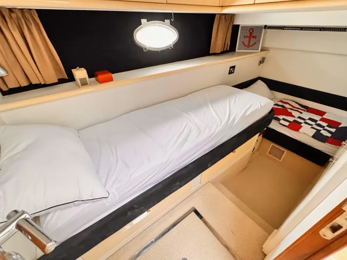 The Enterprise Yacht Photos Pics 1995 Sunseeker MANHATTAN yacht cabin with cozy beds and nautical decor.