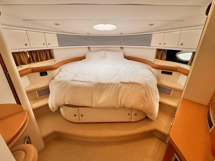 The Enterprise Yacht Photos Pics Luxurious bedroom interior of 1995 Sunseeker MANHATTAN yacht with cozy bed and elegant design.