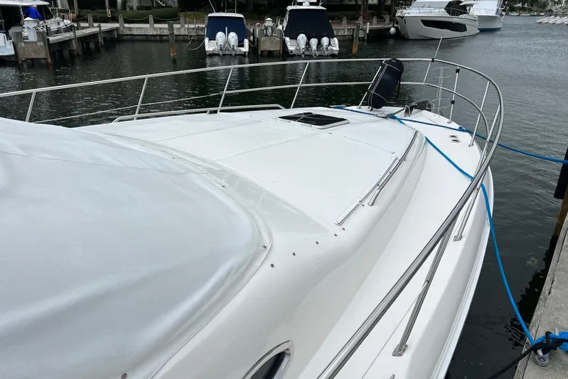  Yacht Photos Pics 2000 Sea Ray 400 Sedan Bridge yacht docked at marina, featuring sleek white design.
