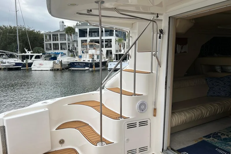  Yacht Photos Pics 2000 Sea Ray 400 Sedan Bridge yacht interior with staircase and marina view.