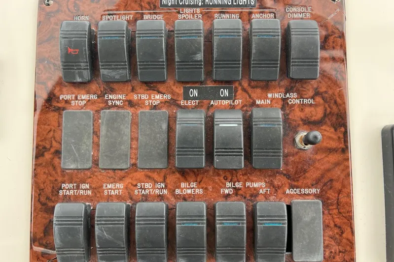  Yacht Photos Pics Control panel of a 2000 Sea Ray 400 Sedan Bridge with labeled switches and toggles.