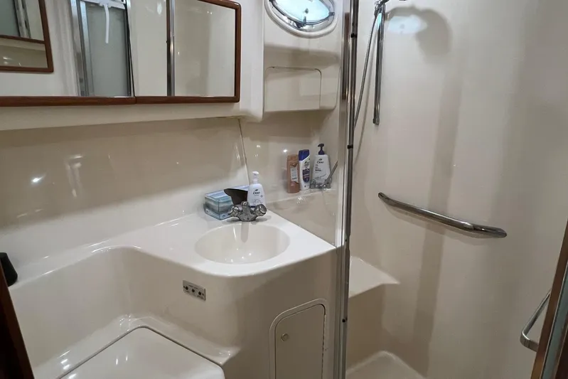  Yacht Photos Pics Bathroom interior of 2000 Sea Ray 400 Sedan Bridge yacht, featuring sink and shower.