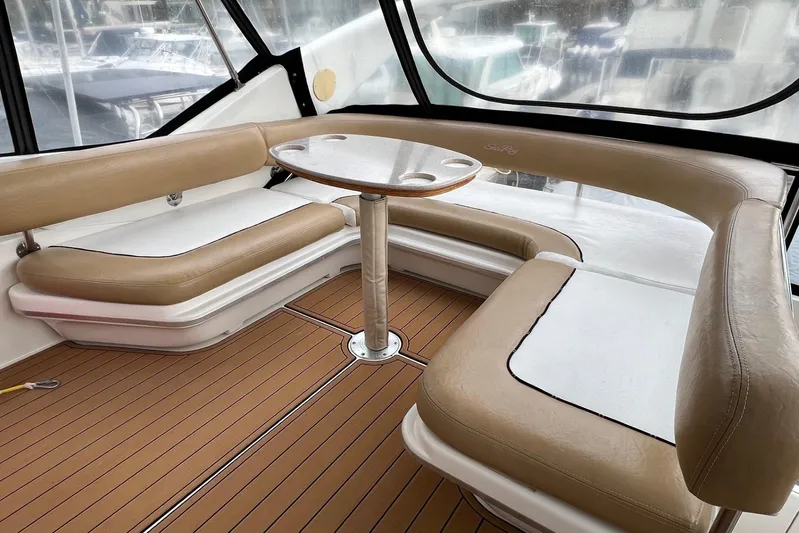  Yacht Photos Pics Luxurious seating area on 2000 Sea Ray 400 Sedan Bridge yacht with tan upholstery and wooden flooring.