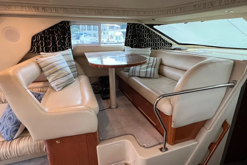  Yacht Photos Pics Interior of 2000 Sea Ray 400 Sedan Bridge with plush seating and dining table.