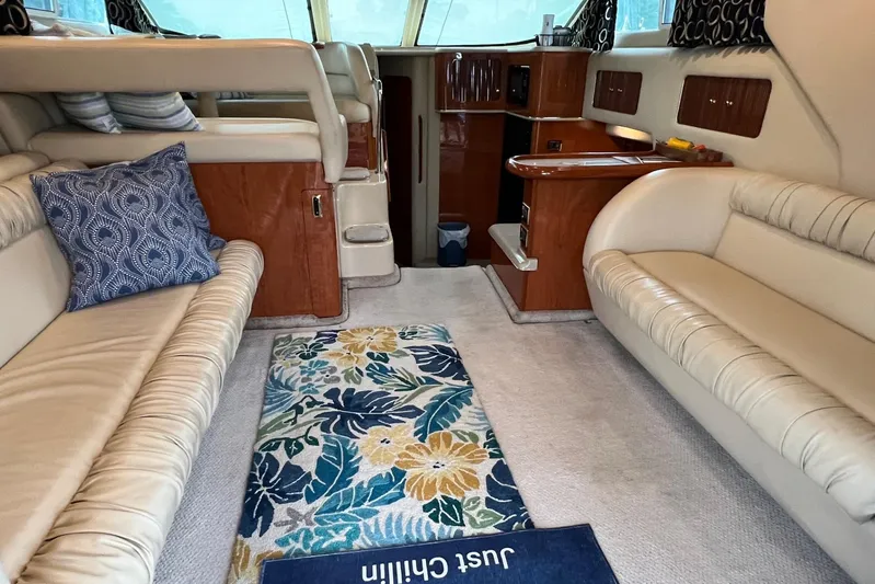  Yacht Photos Pics Interior of 2000 Sea Ray 400 Sedan Bridge with beige seating and floral rug.