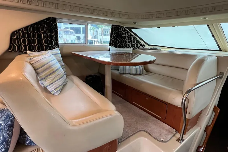  Yacht Photos Pics Interior of 2000 Sea Ray 400 Sedan Bridge with plush seating and dining table.