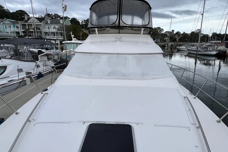  Yacht Photos Pics 2000 Sea Ray 400 Sedan Bridge yacht docked at marina, showcasing sleek design and spacious deck.