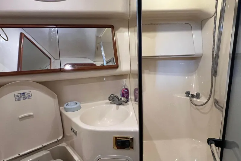  Yacht Photos Pics Bathroom interior of 2000 Sea Ray 400 Sedan Bridge yacht, featuring sink and shower.