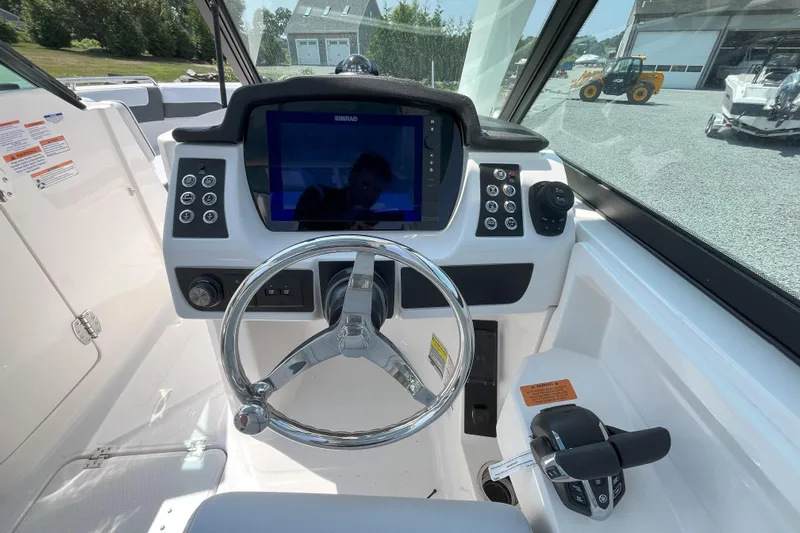  Yacht Photos Pics 2026 Robalo R257 Dual Console helm with steering wheel and navigation display.