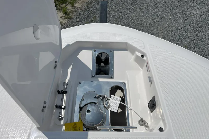  Yacht Photos Pics 2026 Robalo R257 Dual Console anchor compartment with open hatch, showcasing storage and hardware.