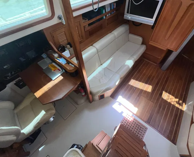 Ruby Lee Yacht Photos Pics Interior of 2006 Island Packet 445 yacht with seating and wooden flooring.