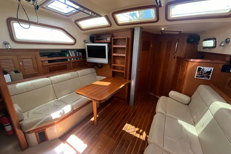 Ruby Lee Yacht Photos Pics Interior of 2006 Island Packet 445 yacht with cozy seating and wooden finishes.